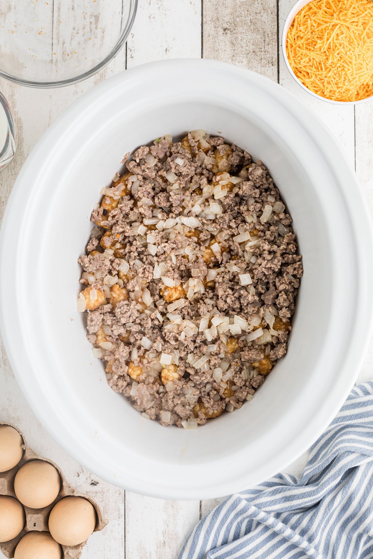 cooked sauage and onion over the tater tots