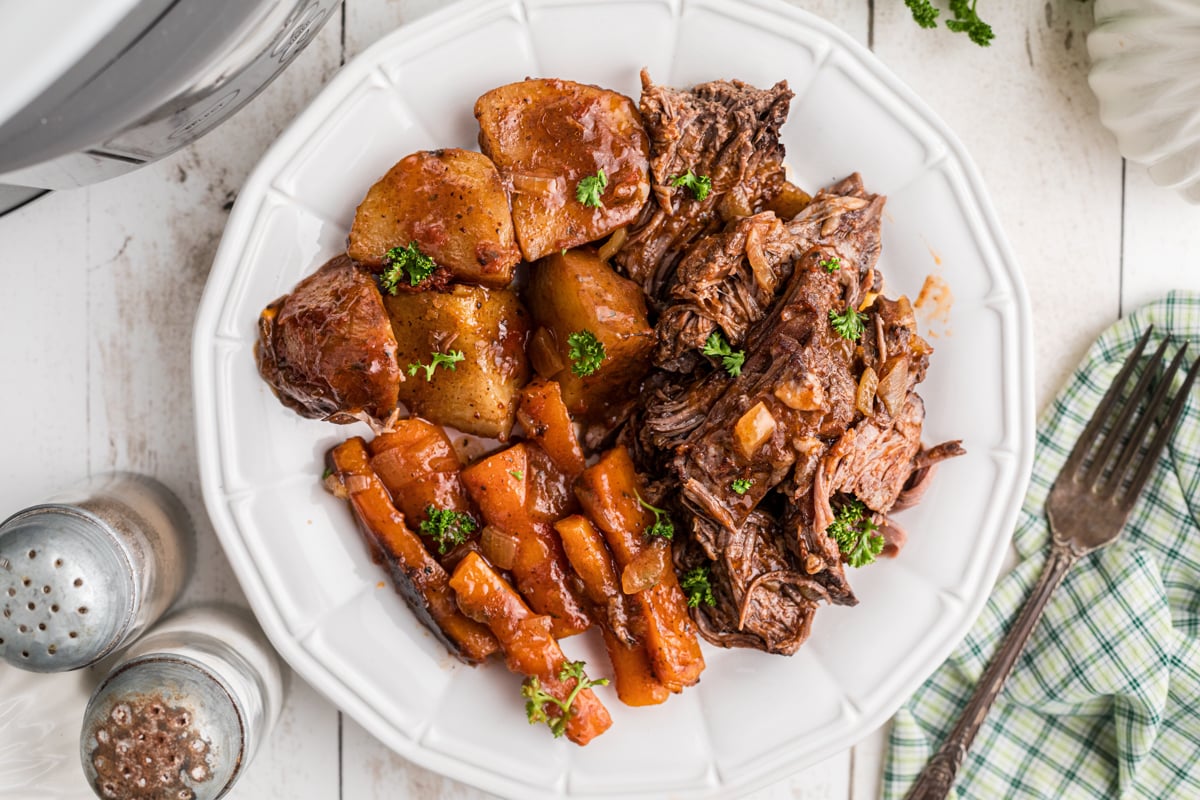 overhead shot of serving of slow cooker italian beef dinner on a plate.