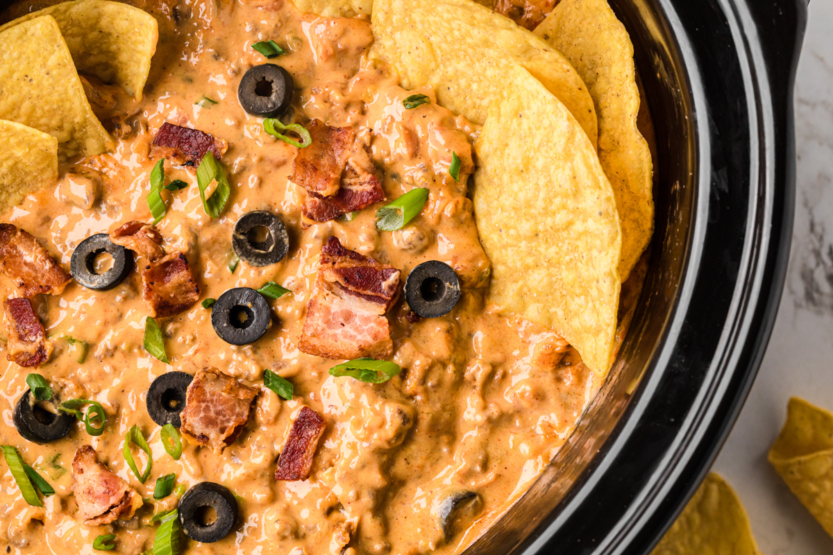 close-up overhead of slow cooker loaded nacho dip.