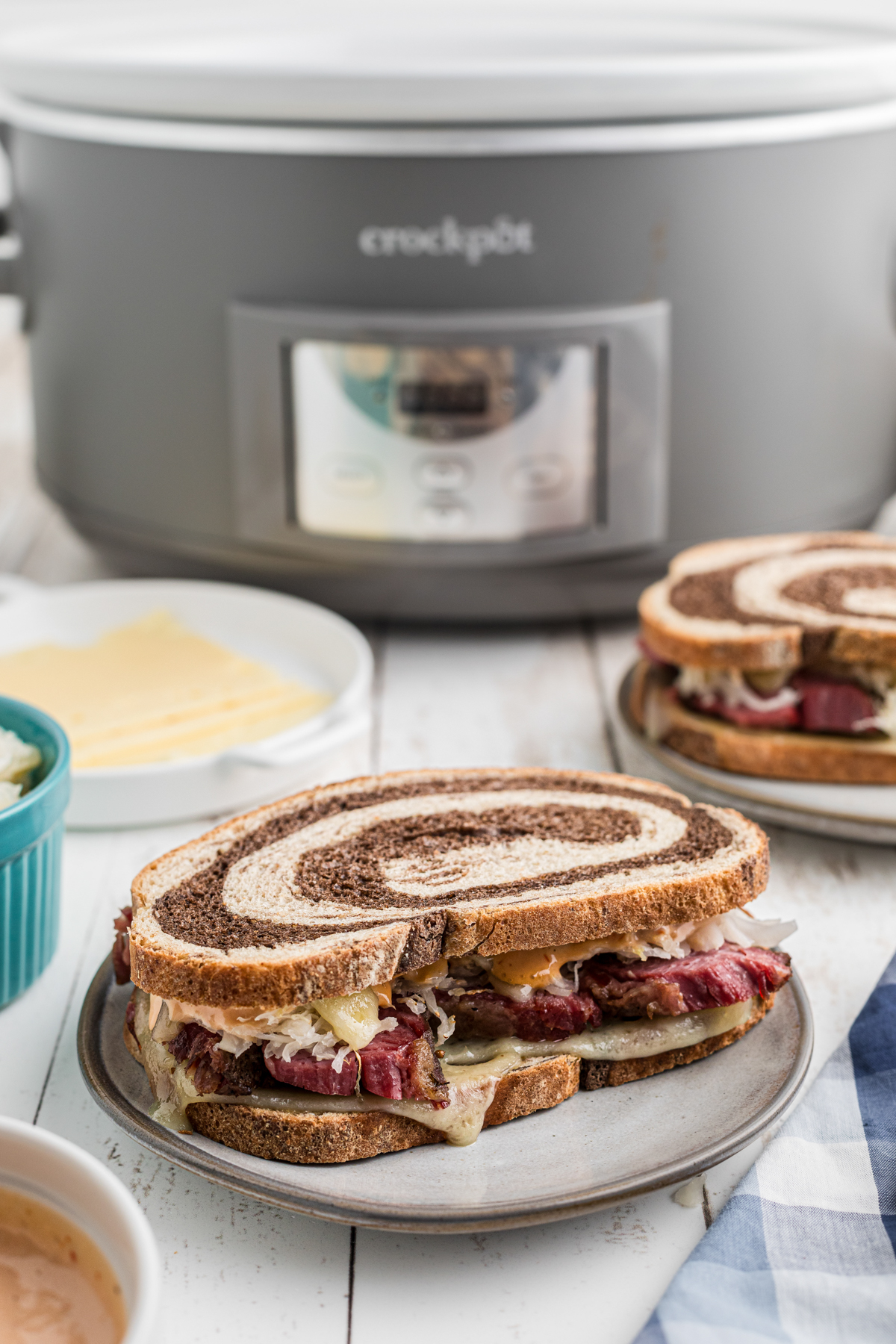 pastrami sandwich in front of a slow cooker.
