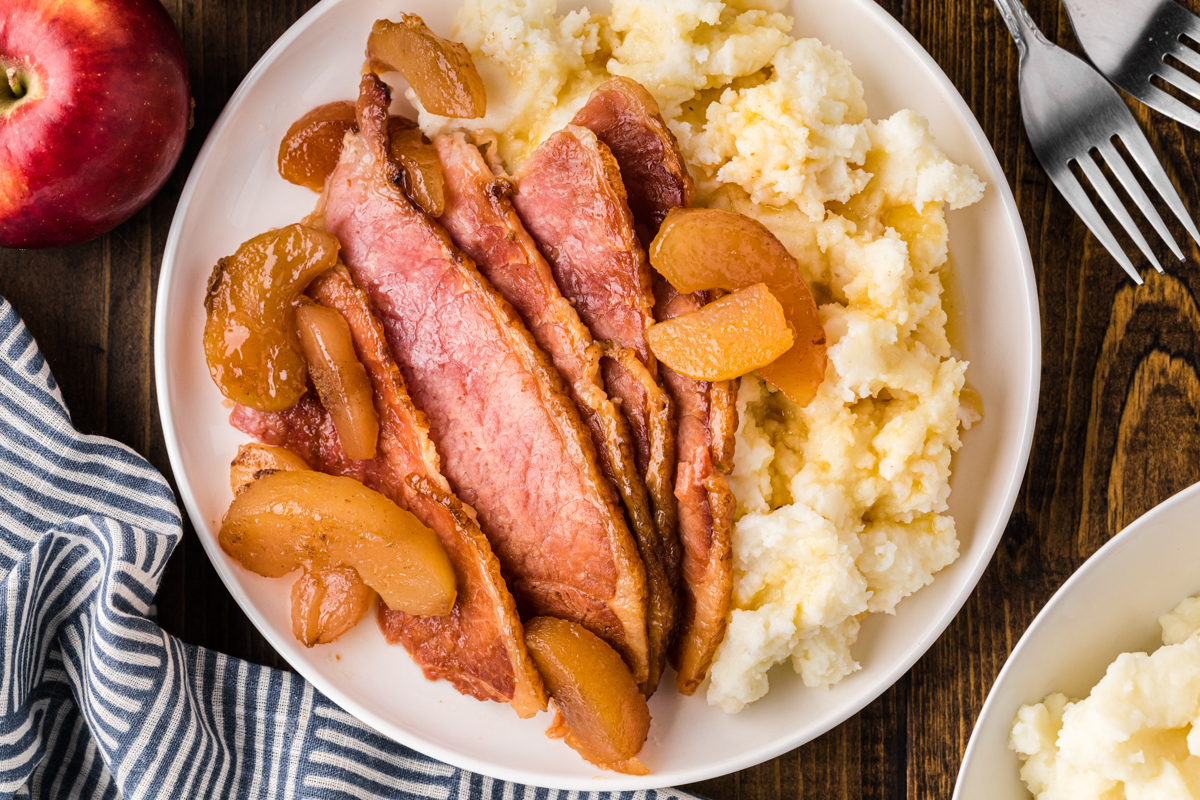 overhead shot of serving of slow cooker apple and clove ham.