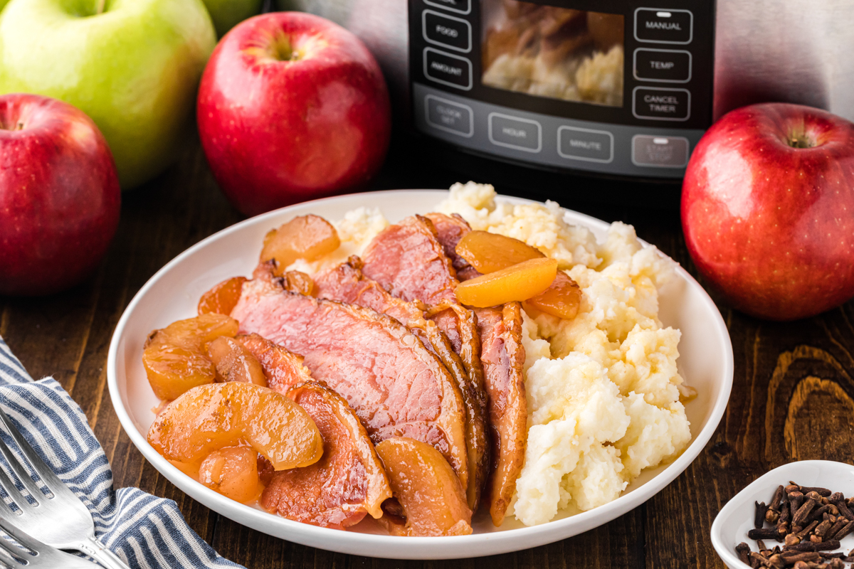 serving of slow cooker apple and clove ham with mashed potatoes.