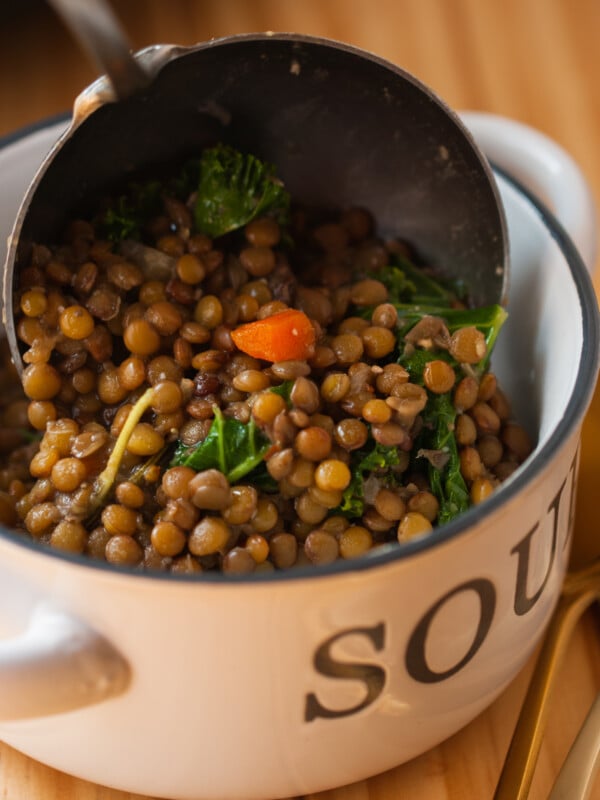 lentils being ladled into a bowl.