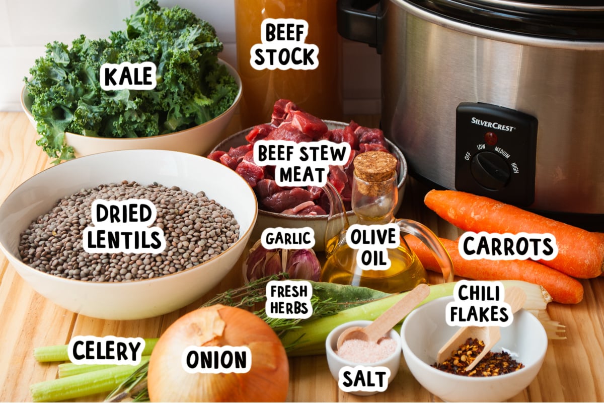 ingredients for slow cooker beef and lentil soup on a table.