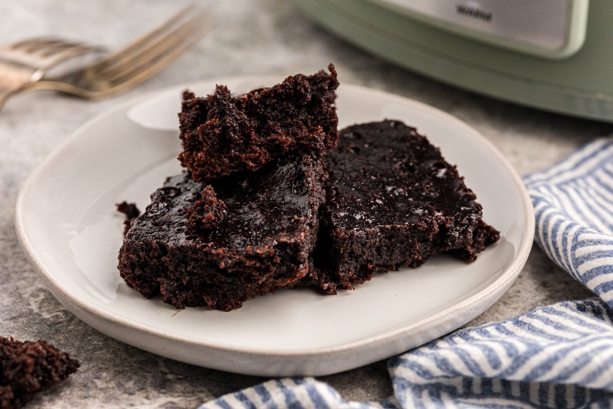 three slow cooker brownies on a plate.