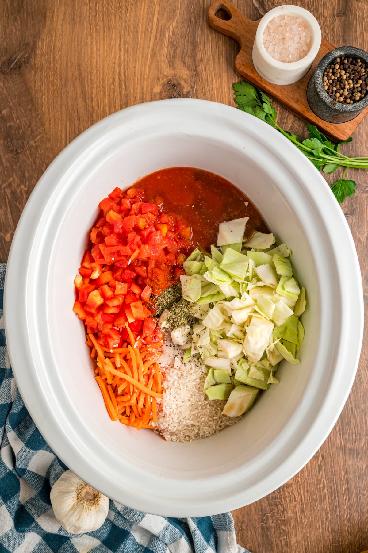 beef, tomatoes, carrots, bell pepper and cabbage in a slow cooker for cabbage soup.