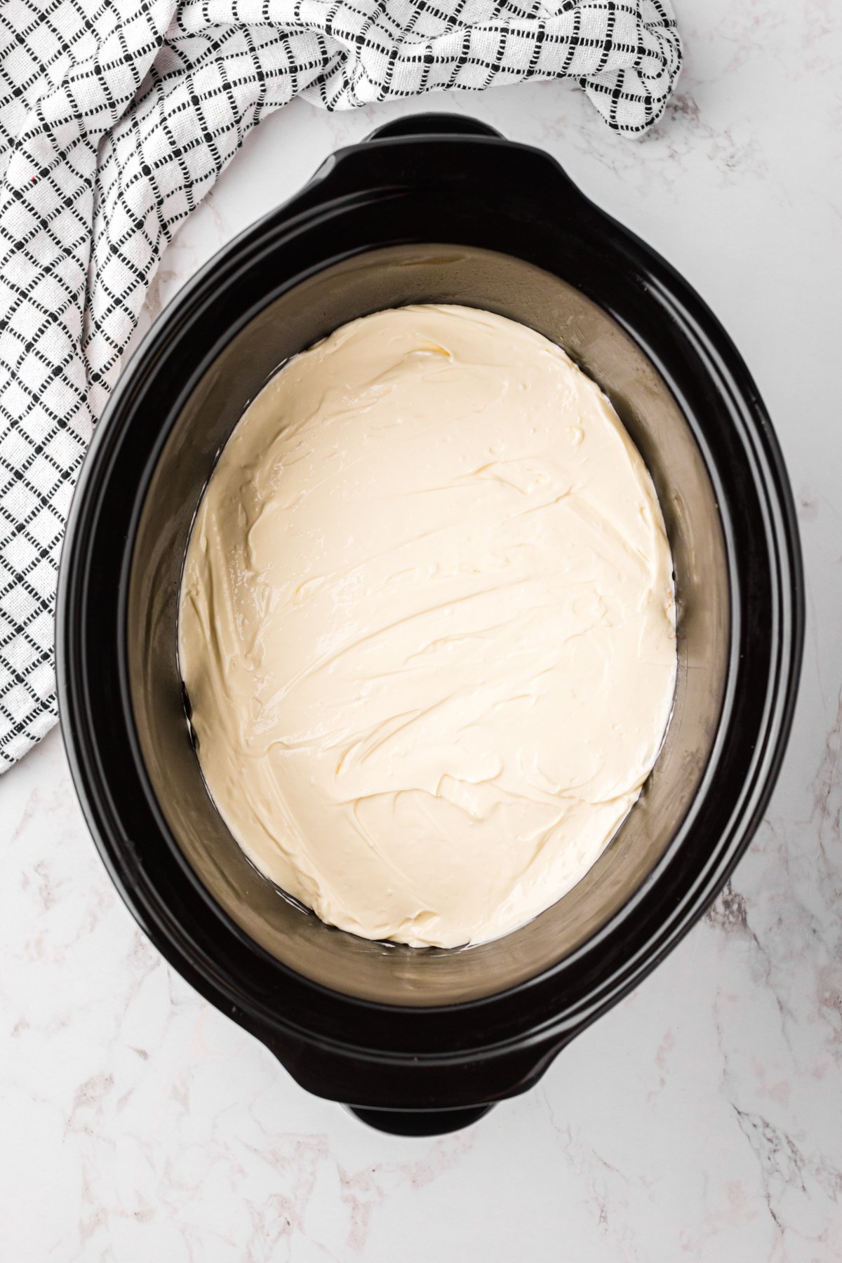 cheesecake ready to cook in a slow cooker.