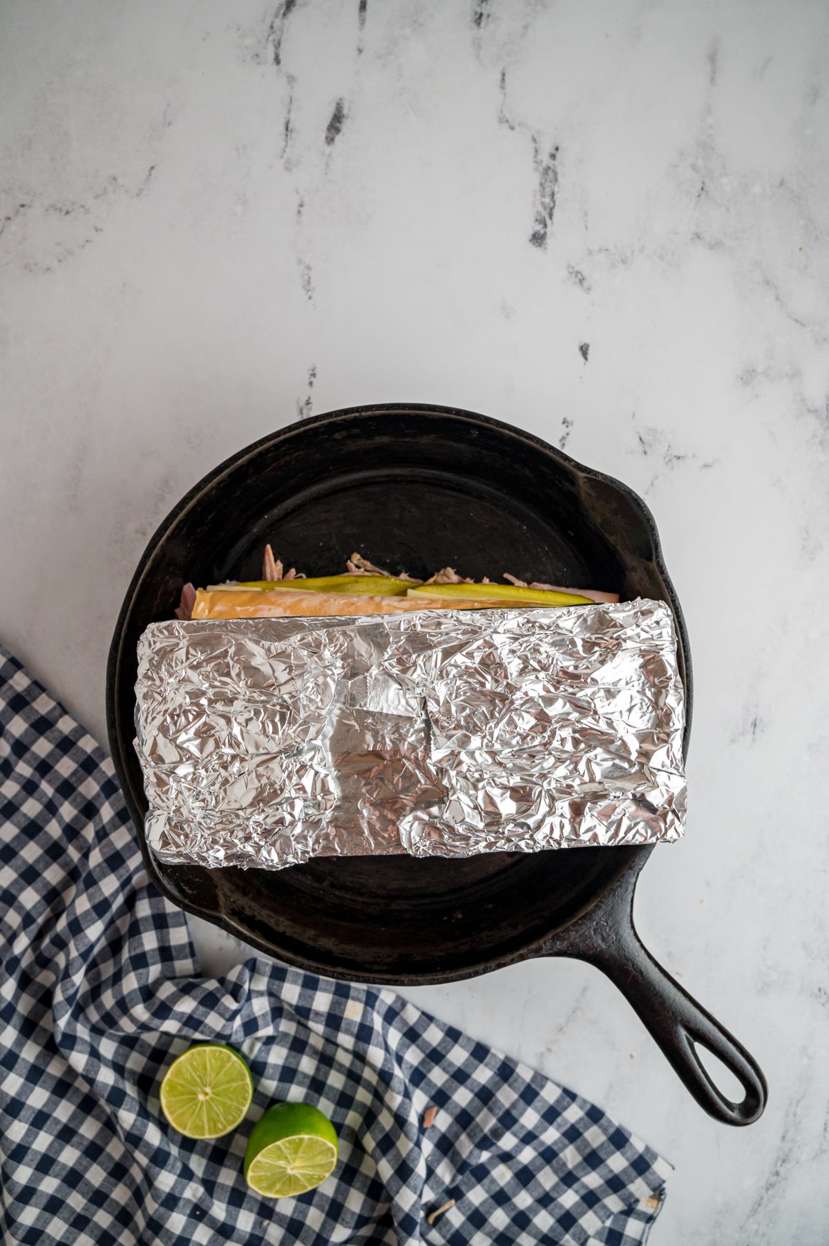 stone on top of cuban sandwich in a slow cooker.