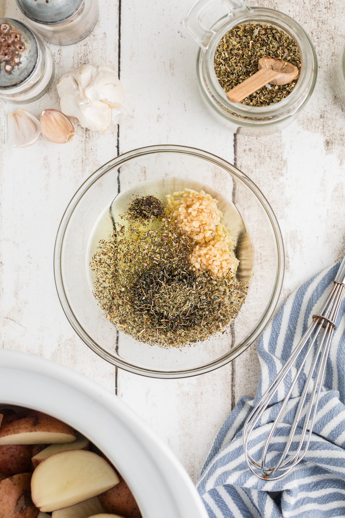 Galic, herbs and oil in a bowl.