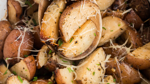 scooping garlic parmesan potatoes from a slow cooker.