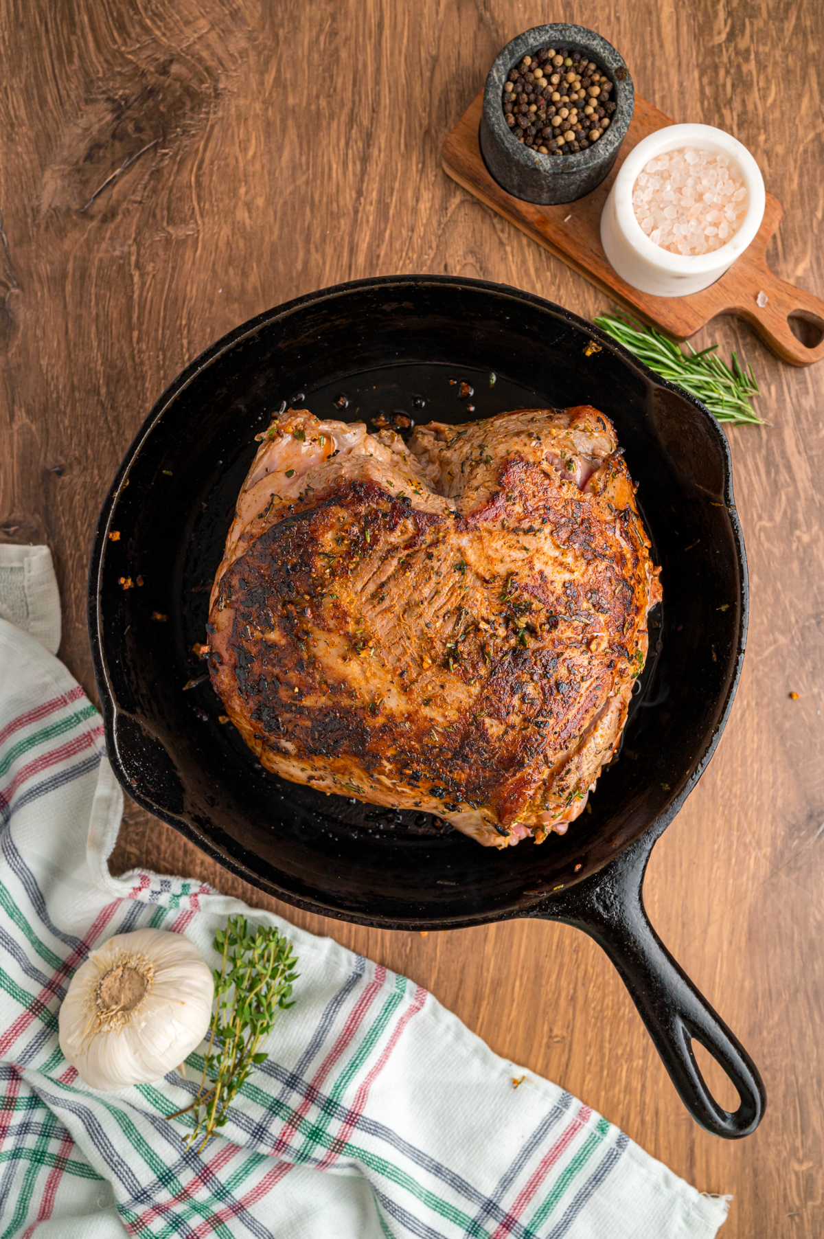 leg of lamb being browned in a skillet.