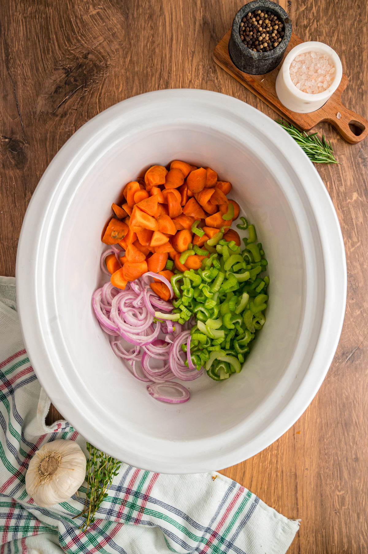 celery, onion and carrots in a slow cooker.