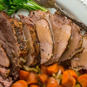 overhead shot of sliced slow cooker lamb.