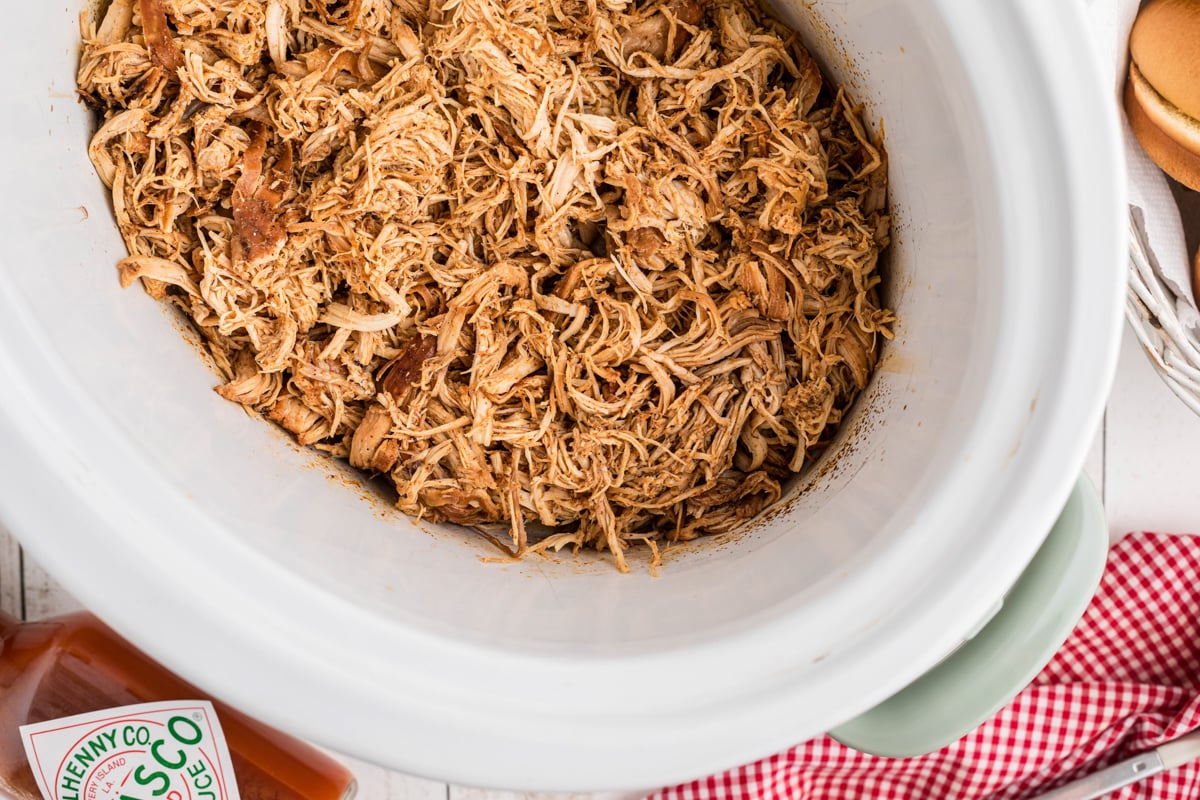 overhead of meat for slow cooker nashville hot chicken sandwiches.