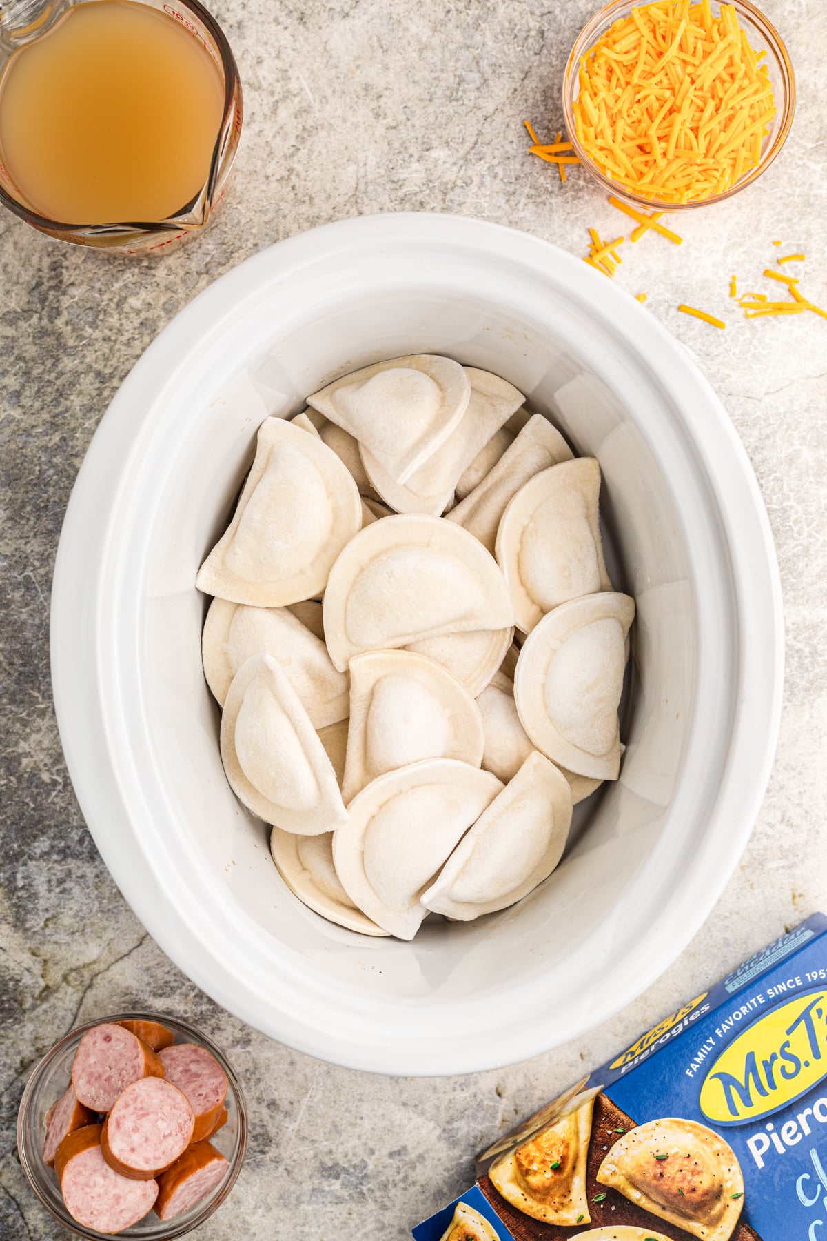Frozen cheese pierogies in a slow cooker.