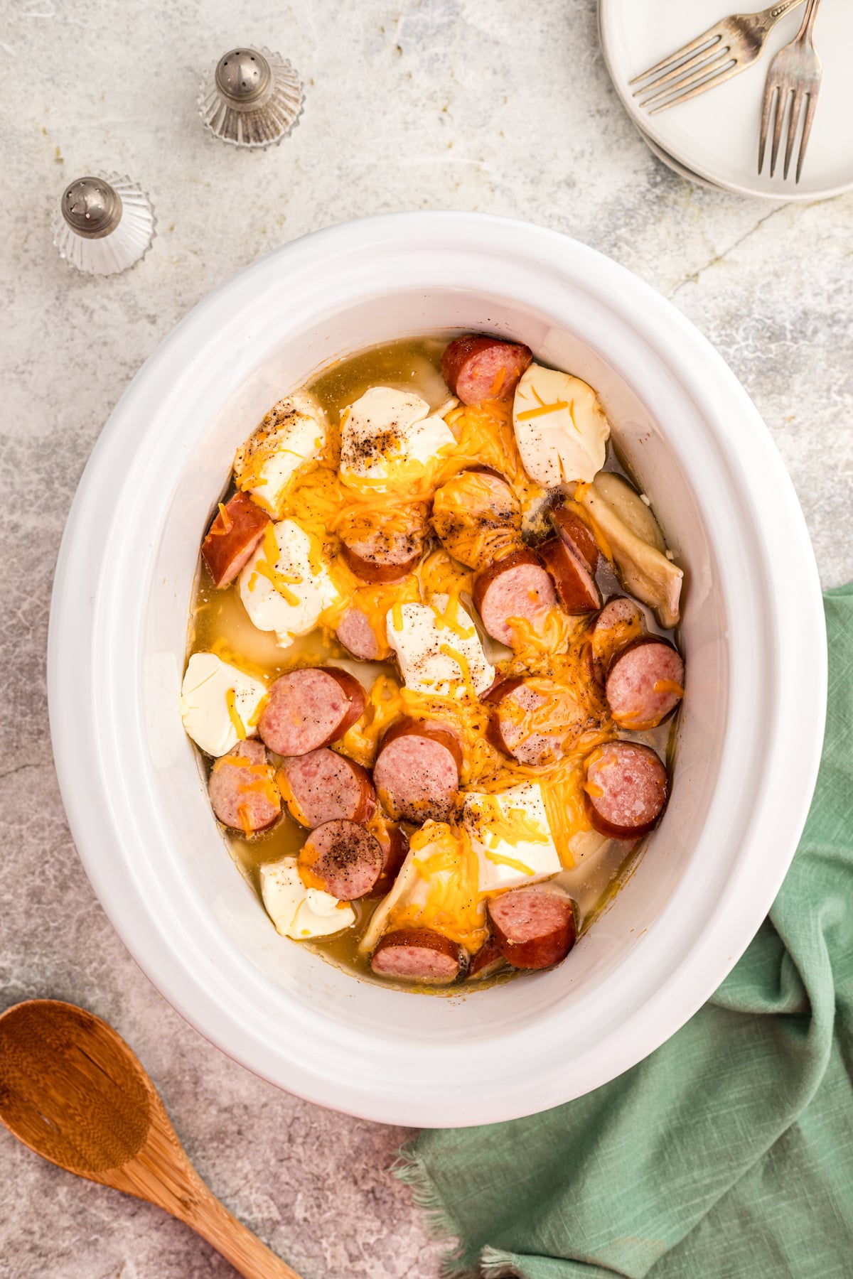 cheese, kielbasa, pierogies and cream cheese in a slow cooker.
