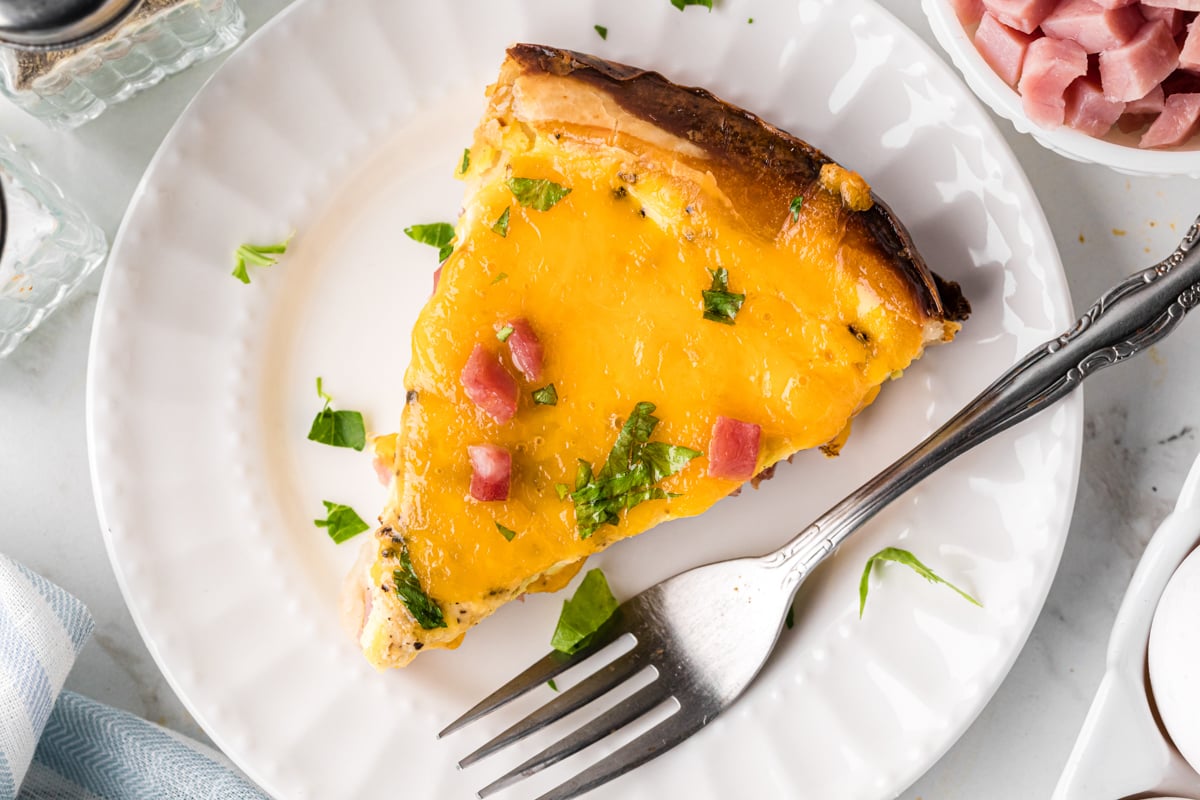 overhead shot of slice of slow cooker quiche on a plate.