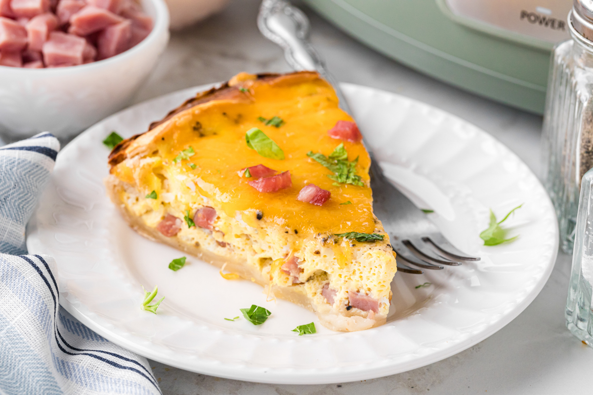 slice of slow cooker quiche on a plate.