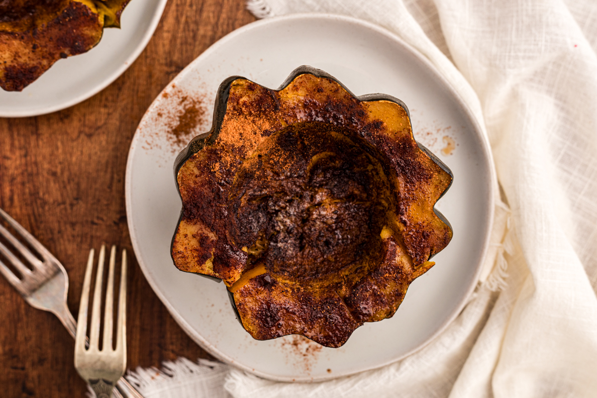 overhead shot of slow cooker acorn squash half on a plate.