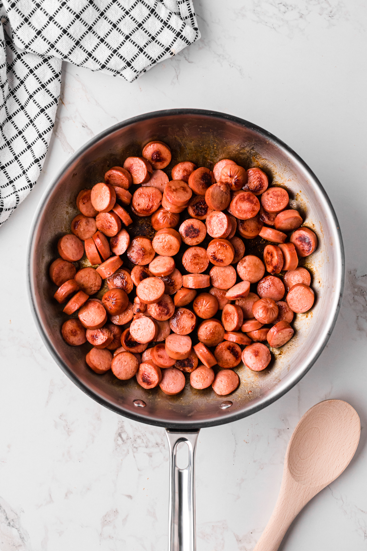 cut hot dogs browning in a skillet.