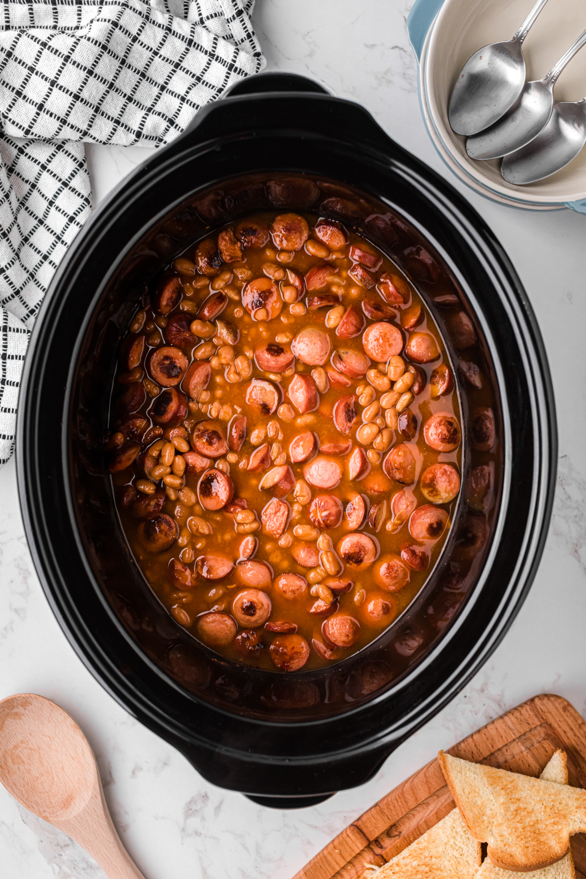 overhead of beanies and weenies in a crockpot after cooking.