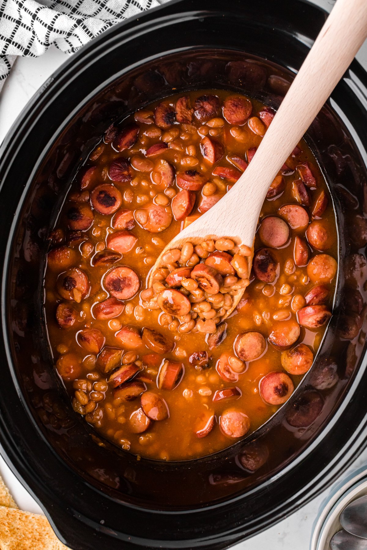 scooping out some slow cooker beanies and weenies.