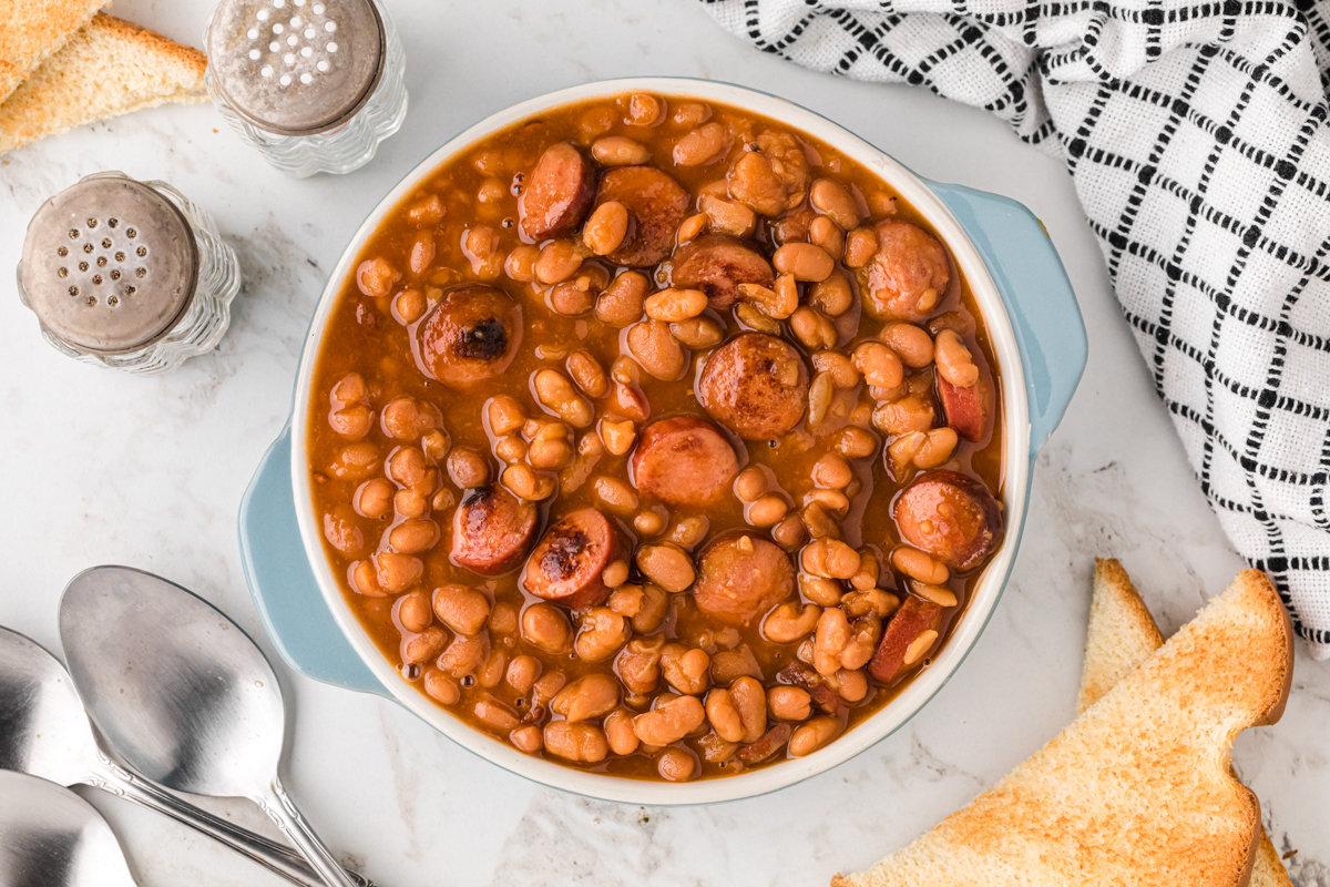 overhead of serving of slow cooker beanies and weenies in a bowl.