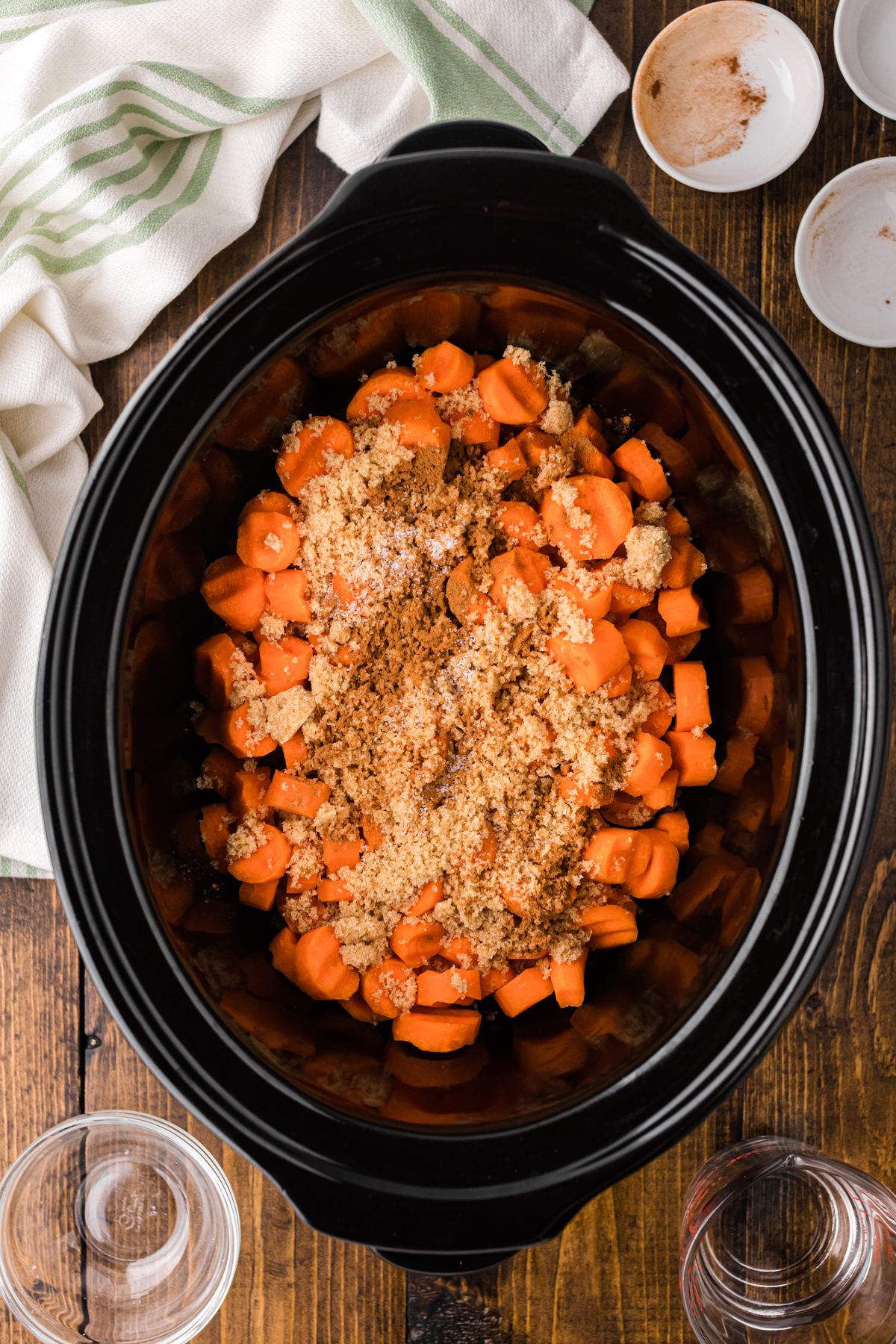 cinnamon, nutmeg, and salt added to sliced carrots in a slow cooker.