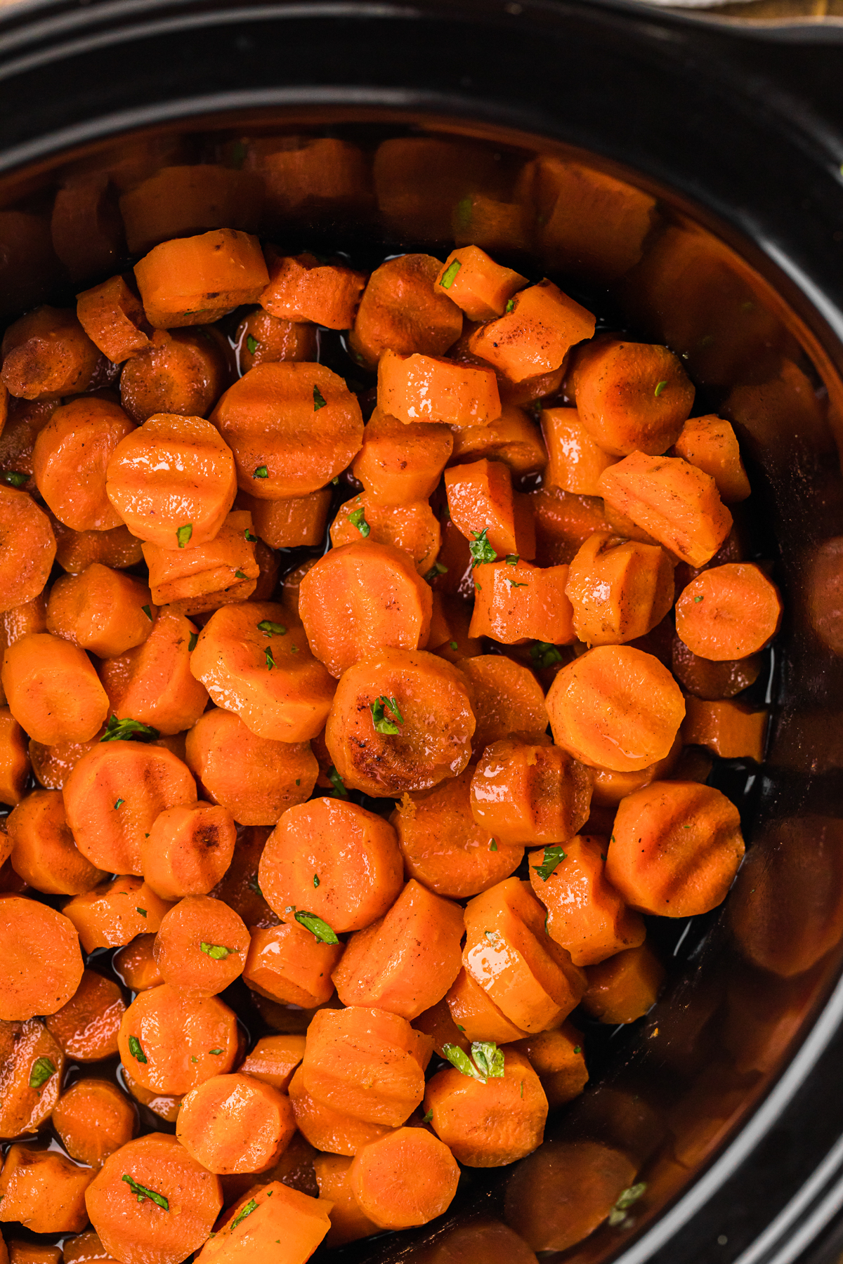 overhead shot of candied carrots in a slow cooker.
