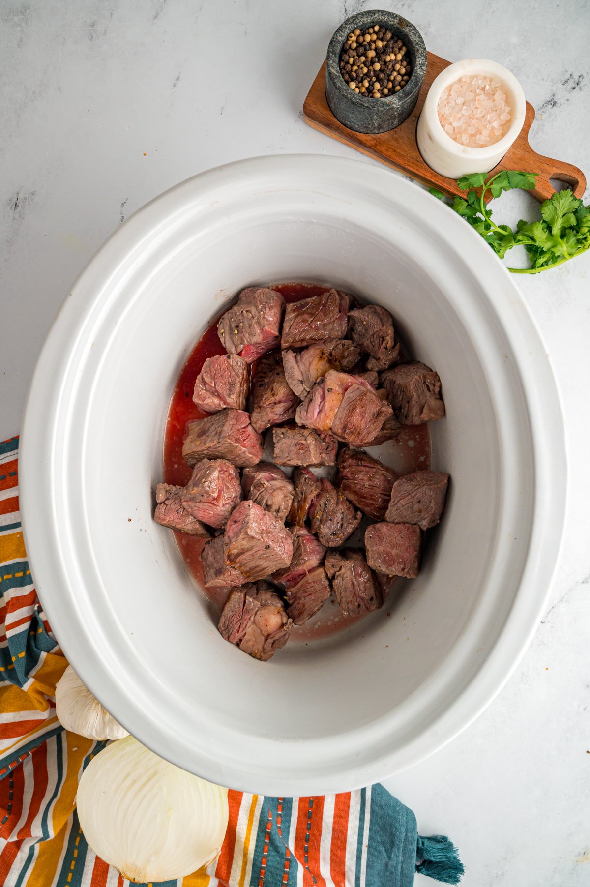 chuck roast added to a slow cooker.