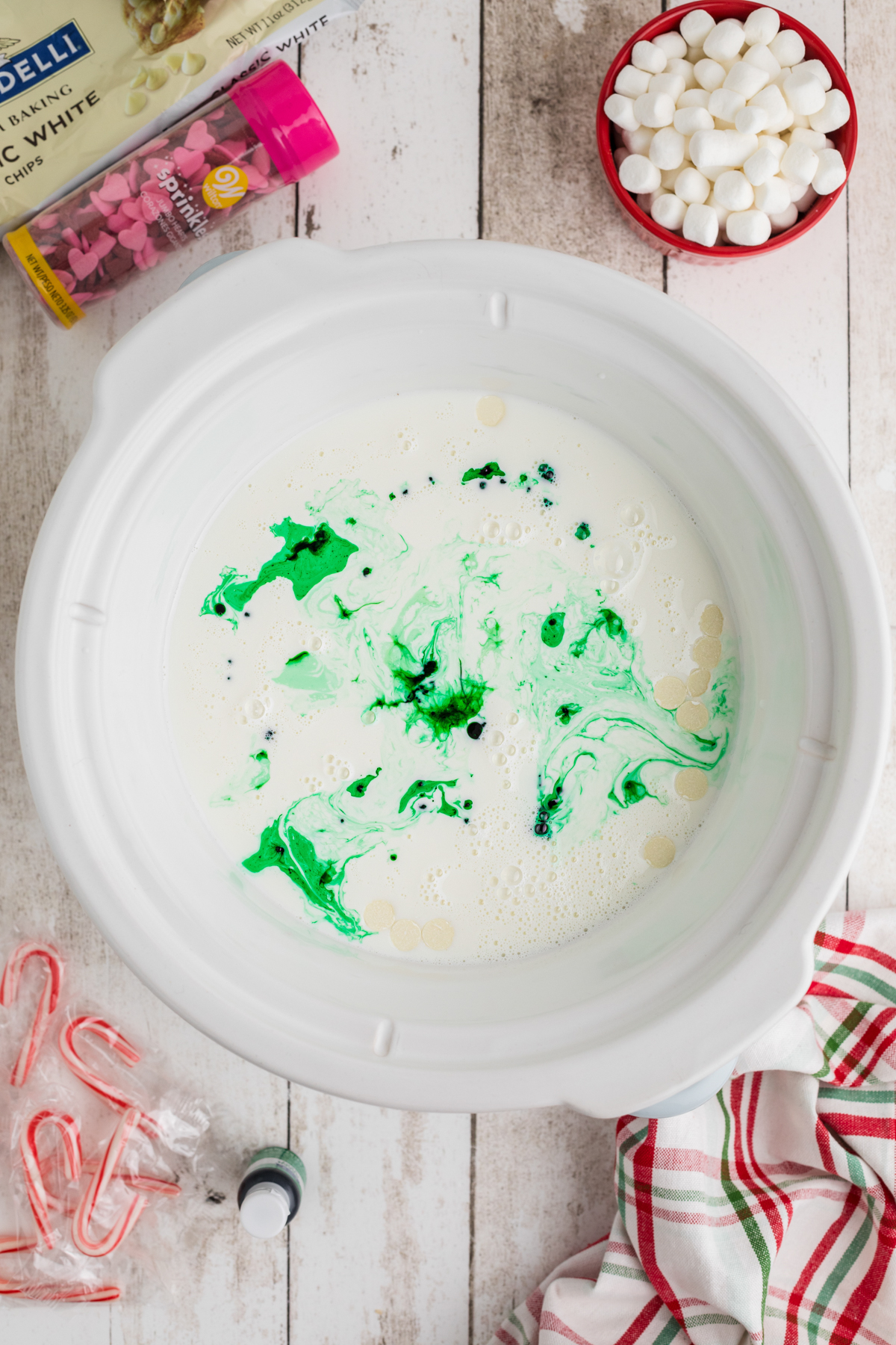 Green food coloring added to crockpot to make grinch hot chocolate.