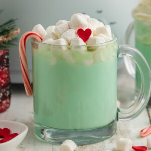 Close-up of slow cooker grinch hot chocolate in a clear mug.