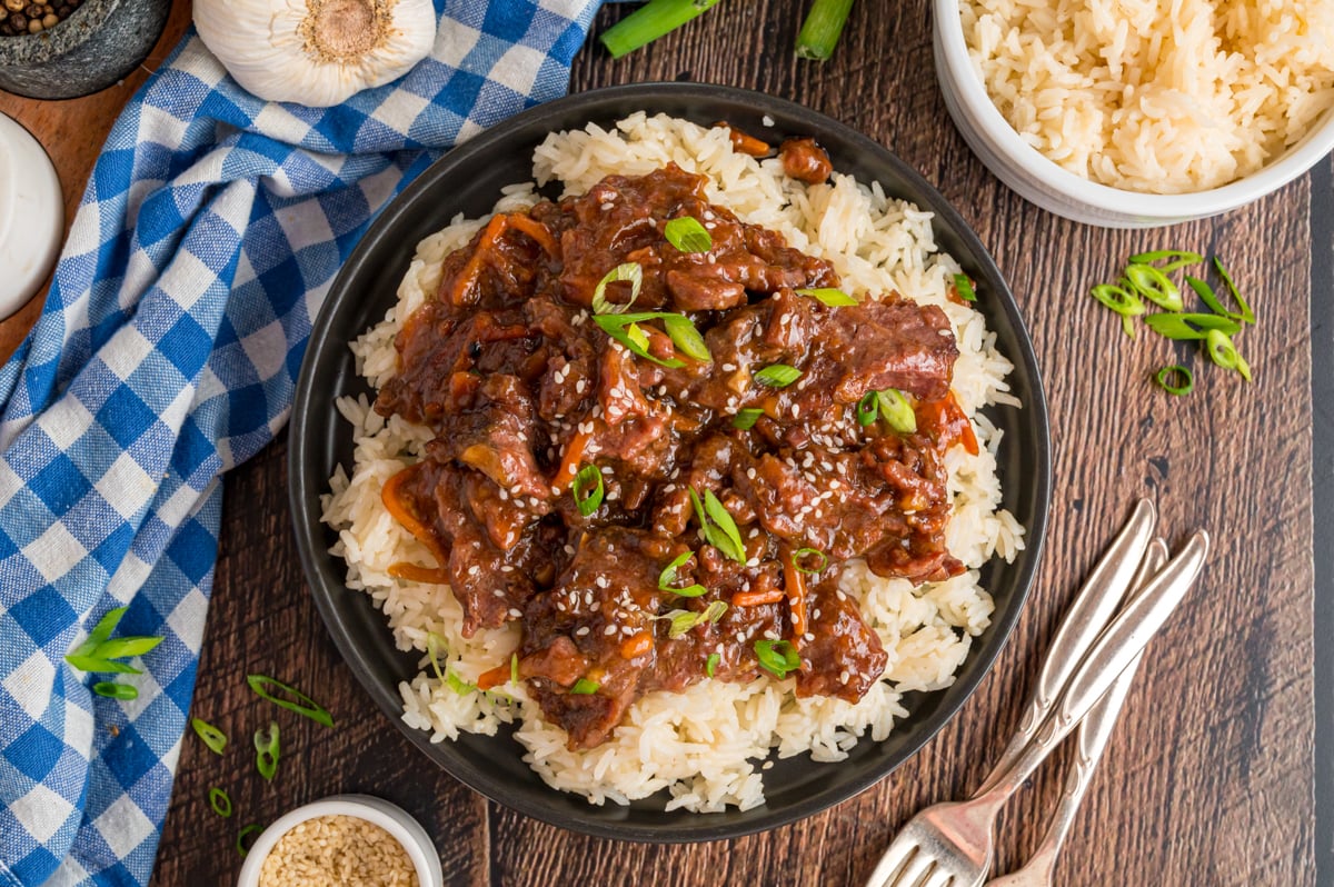 overhead of serving of slow cooker mongolian beef over rice.