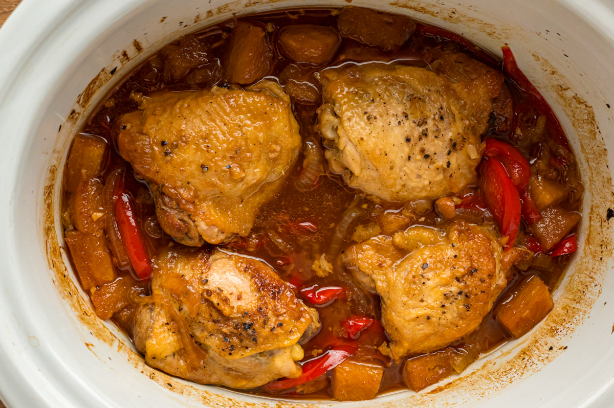 close-up overhead of slow cooker pineapple chicken in a crockpot.