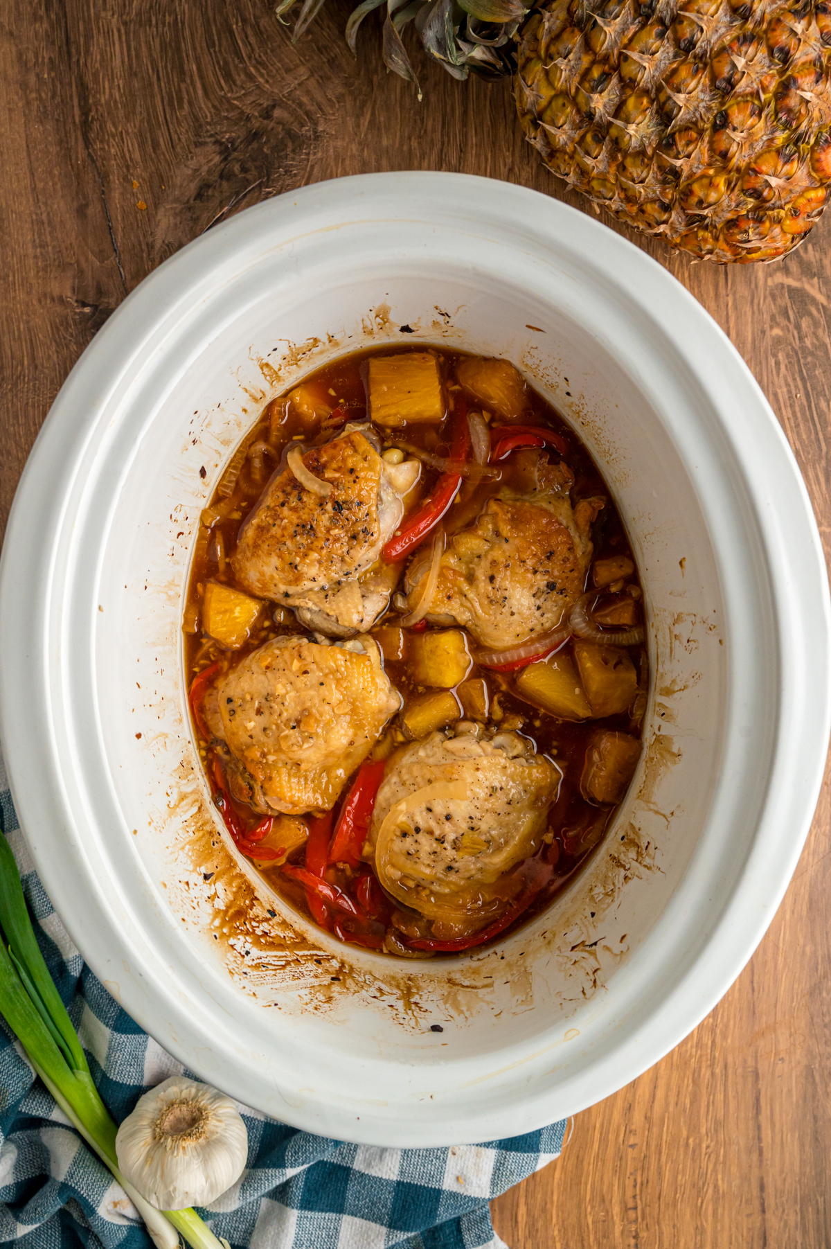 slow cooker pineapple chicken in a crockpot after cooking before adding cornstarch.