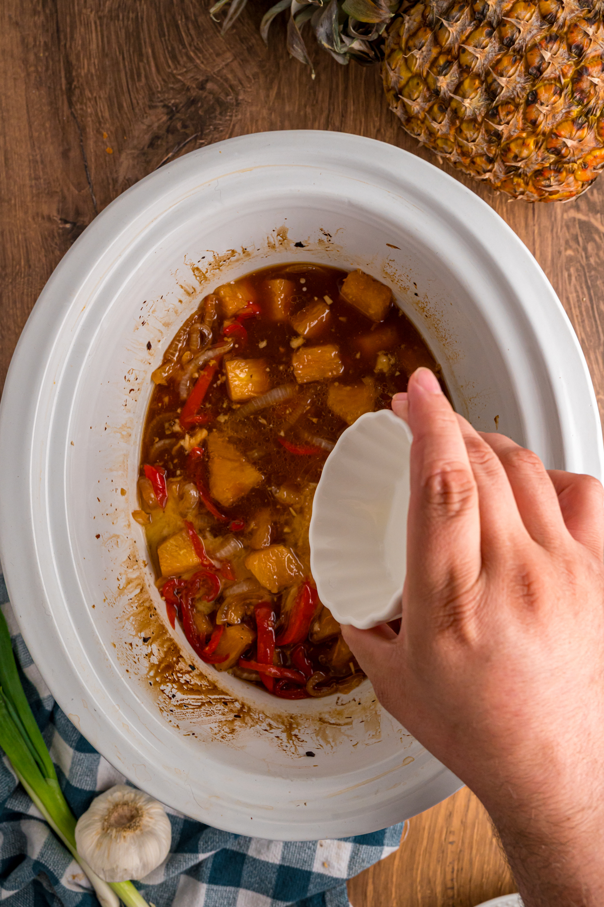 adding cornstarch slurry to sauce in a crockpot after chicken was removed.