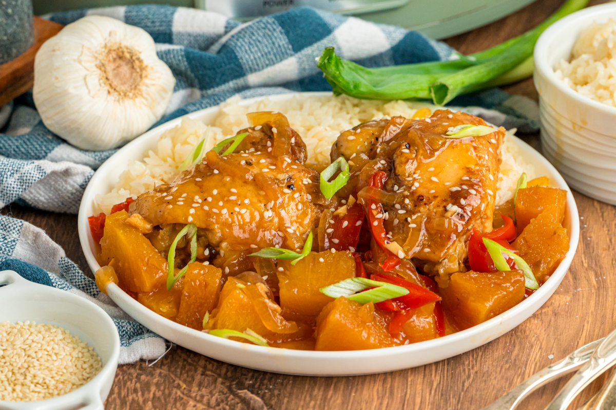 serving of slow cooker pineapple chicken with rice on a plate.