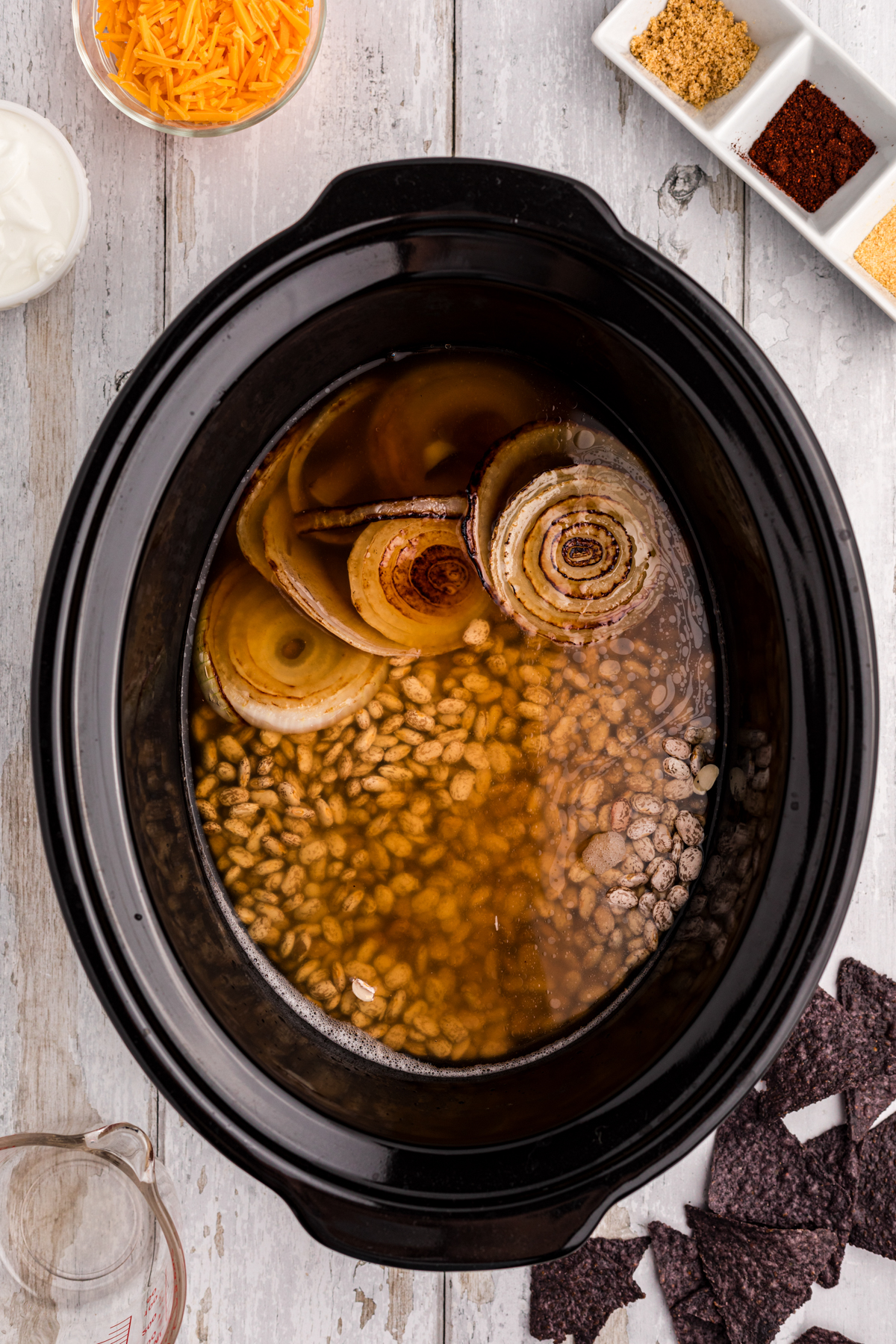 ingredients for slow cooker refried beans soup in a crockpot before cooking.