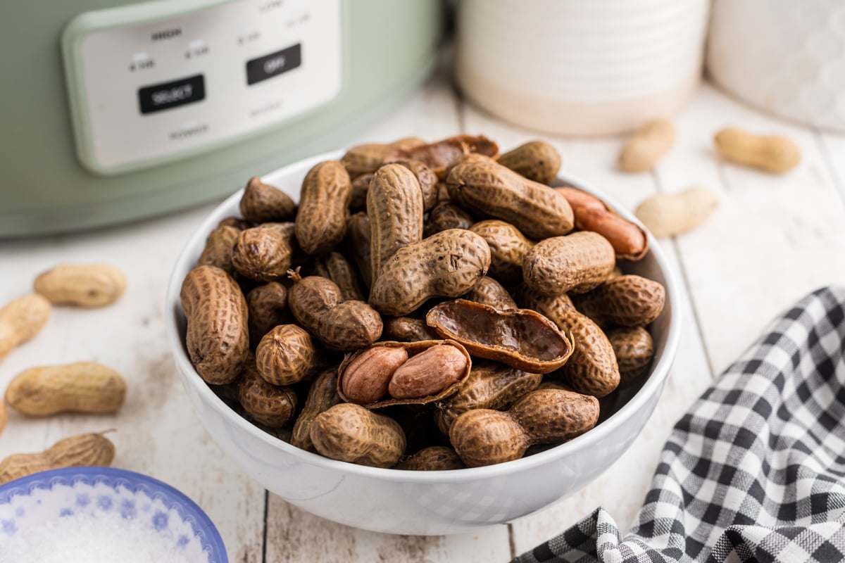 Slow cooker boiled peanuts in a white bowl.