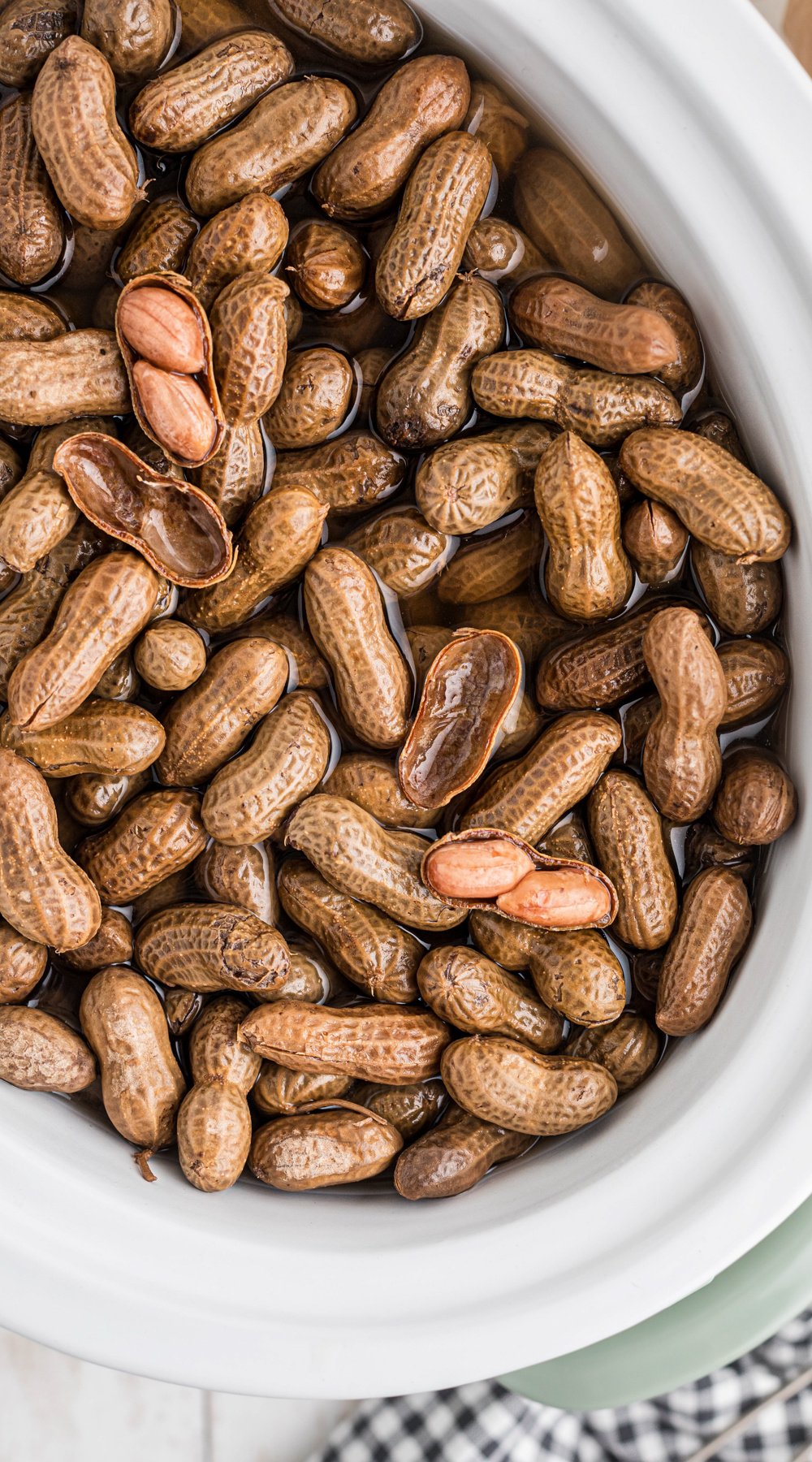 Long image of slow cooker boiled peanuts.