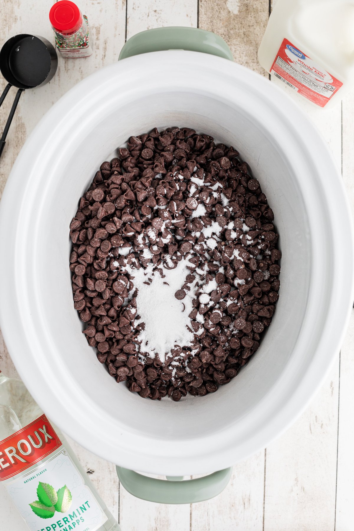 Chocolate chips and sugar in a crockpot.
