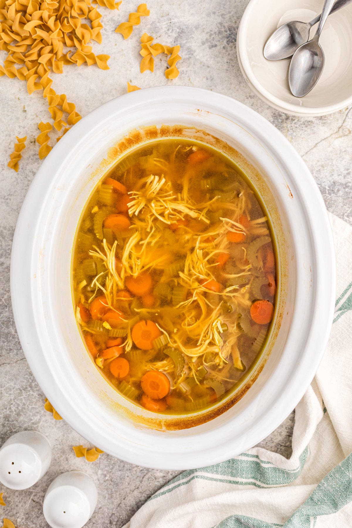 Curried chicken noodle soup in a crockpot after cooking before adding the pasta.