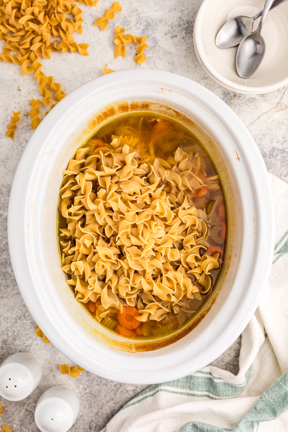 Pasta added to soup in a crockpot.