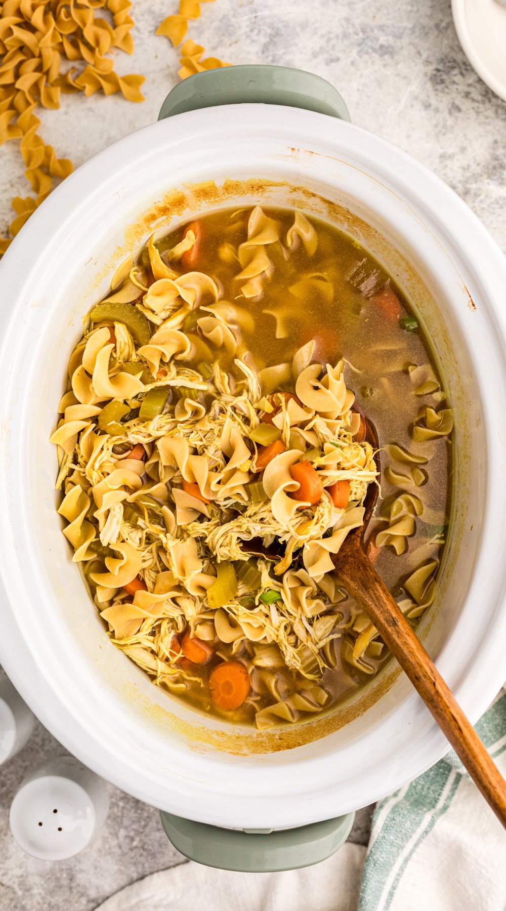 Long image of slow cooker curried chicken noodle soup.