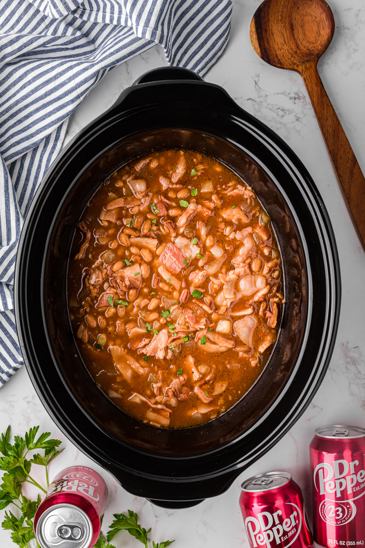 slow cooker dr. pepper baked beans in a crockpot after cooking.