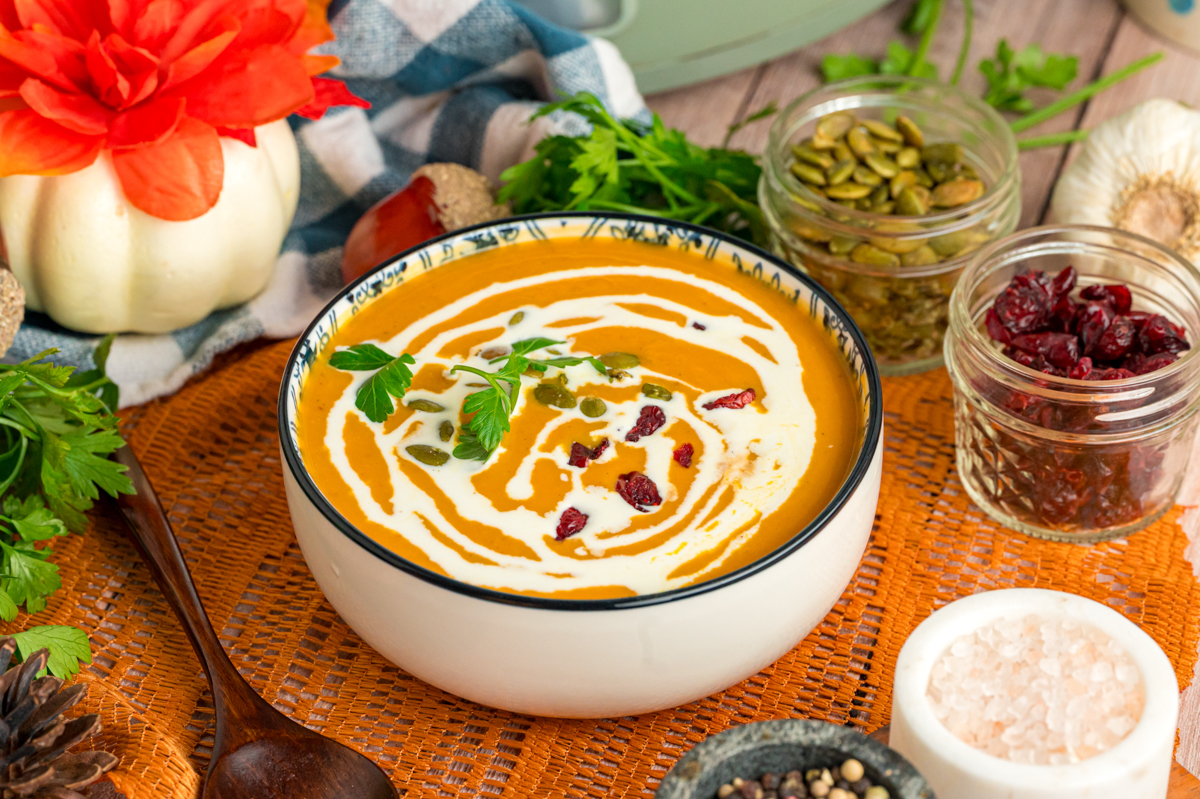 Slow cooker pumpkin soup in a white bowl.