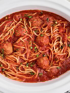 Slow cooker spaghetti and meatballs in a crockpot after cooking.