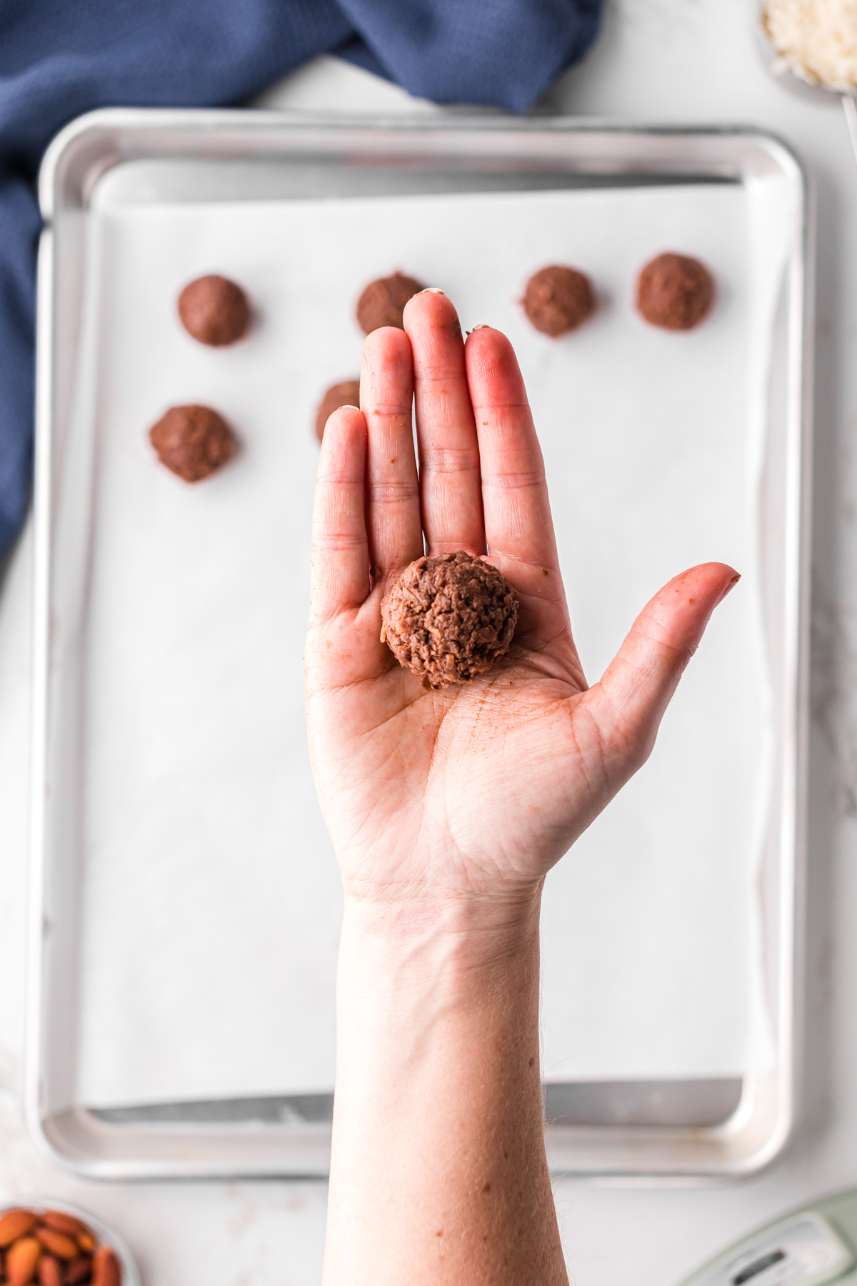 Rolling almond joy mixture into balls.