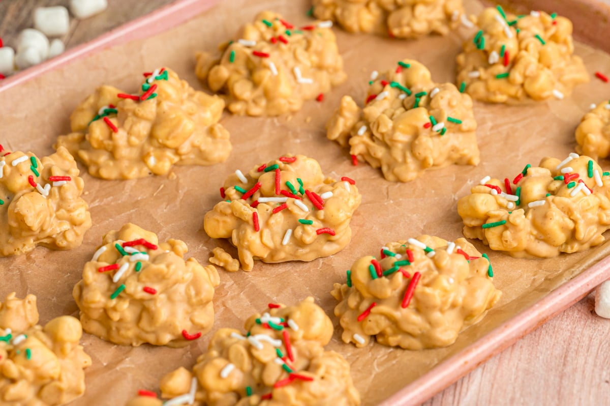Slow cooker avalanche cookies with holiday sprinkles on a baking sheet.