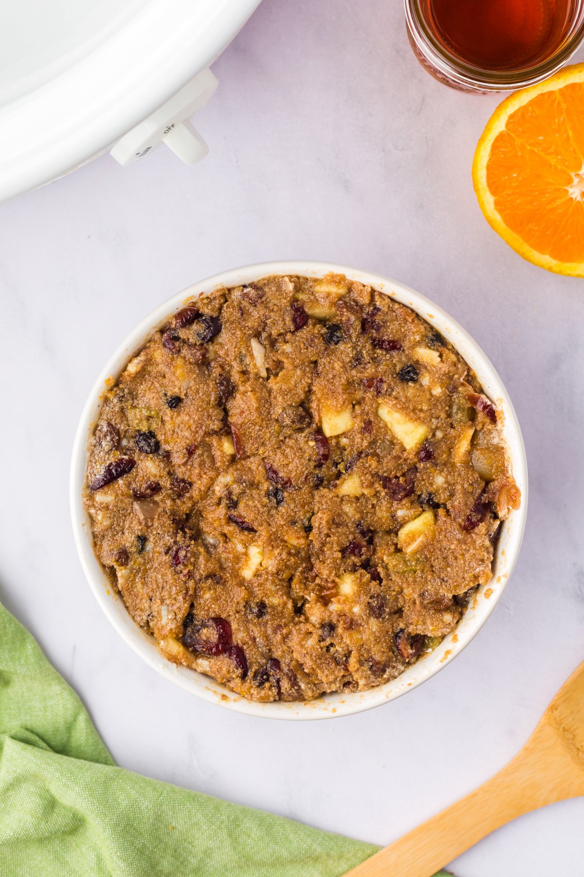 Figgy pudding mixture in a white pudding basin.